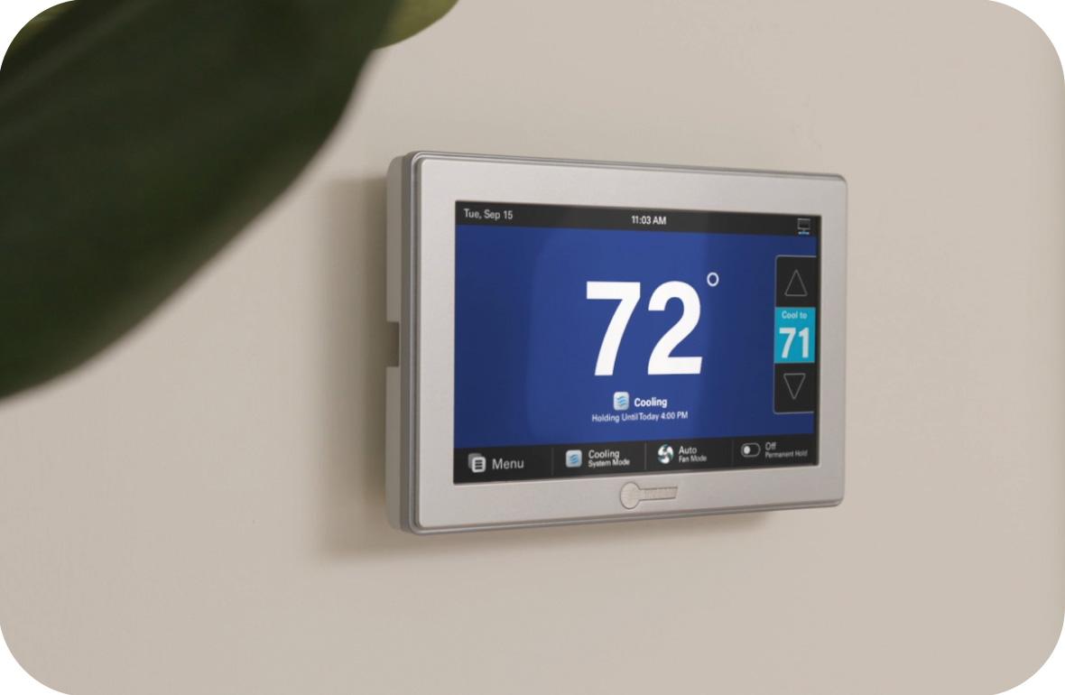 A home thermostat on the wall is set to 72 degrees.