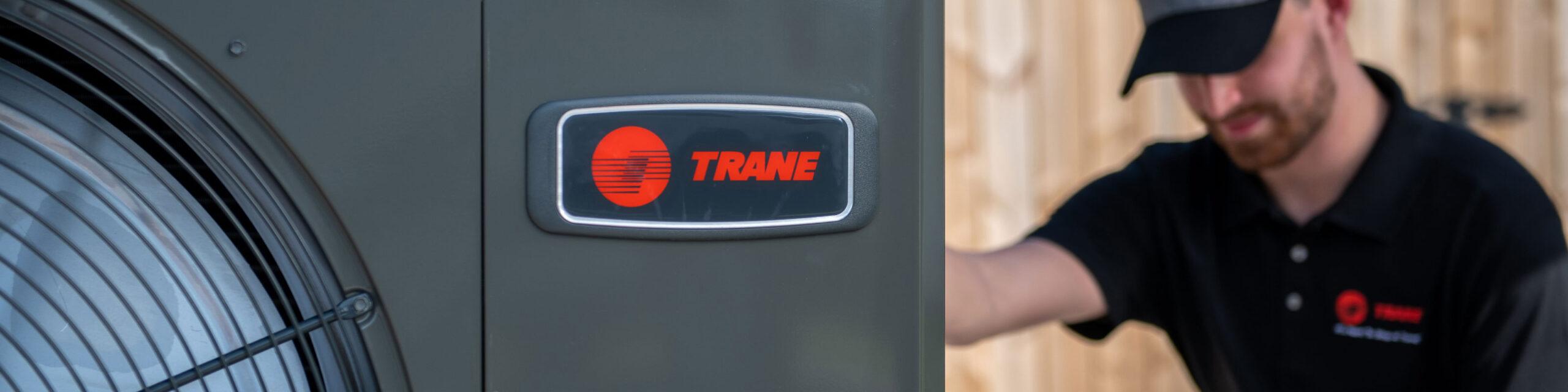 Trane HVAC technician performing maintenance on a Trane branded HVAC system
