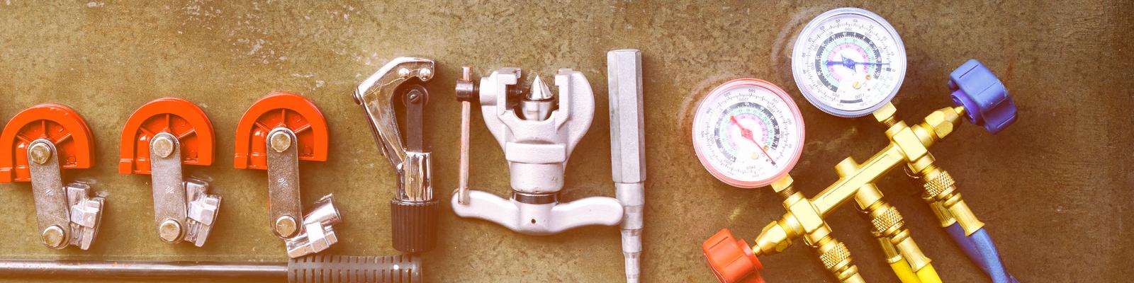 There is a selection of HVAC tech tools laid out on a table.
