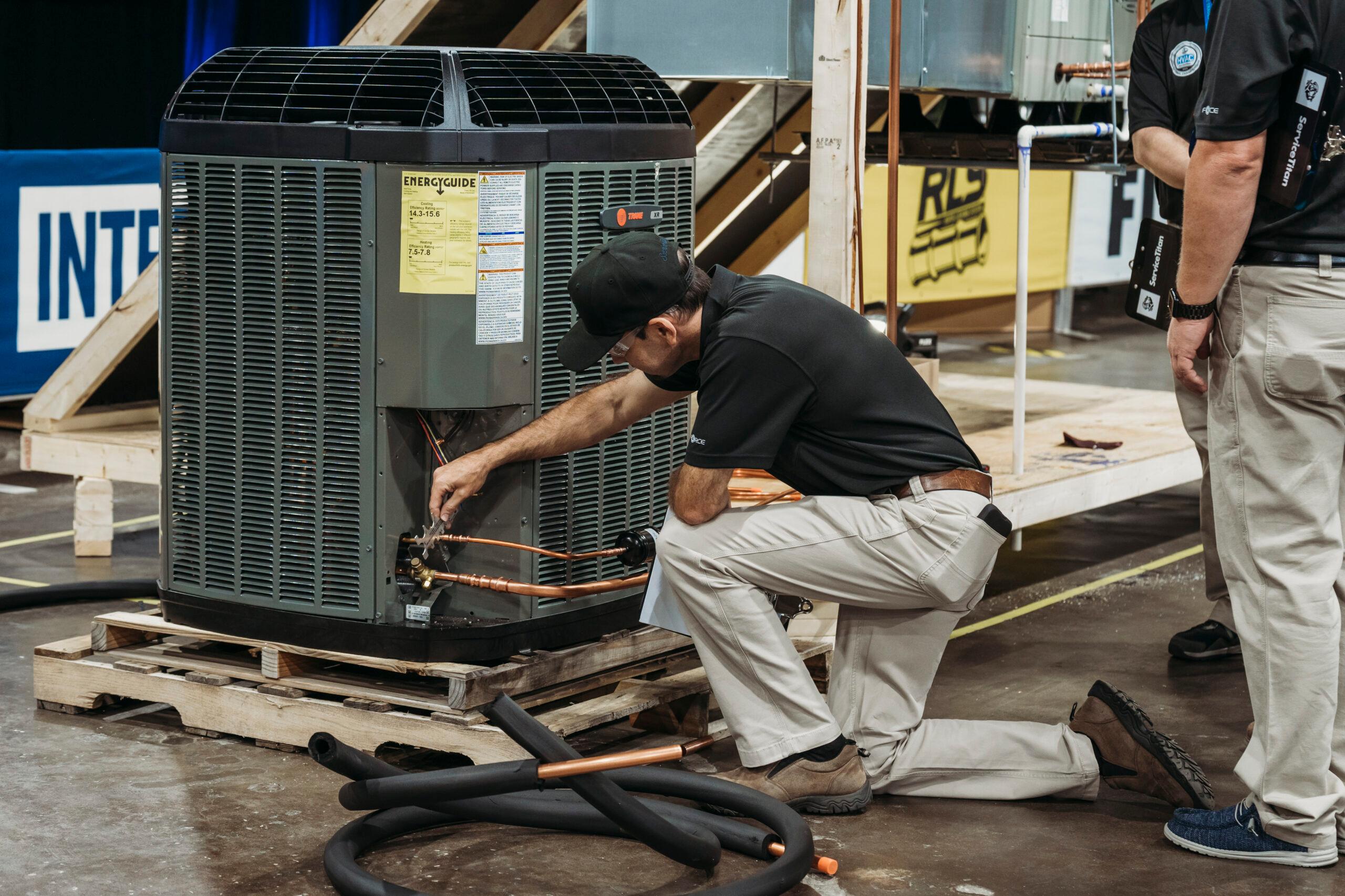 A Trane technician is working on a unit.